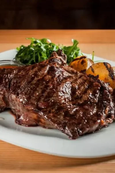 beautiful-juicy-steak-with-salad-plate-is-wooden-table